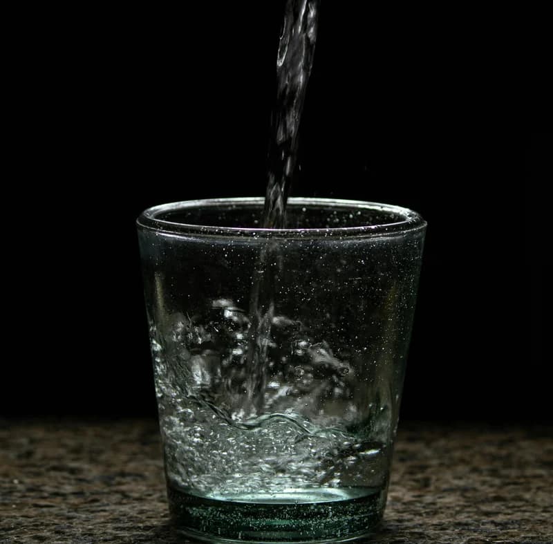 Clear drinking water being poured into a glass