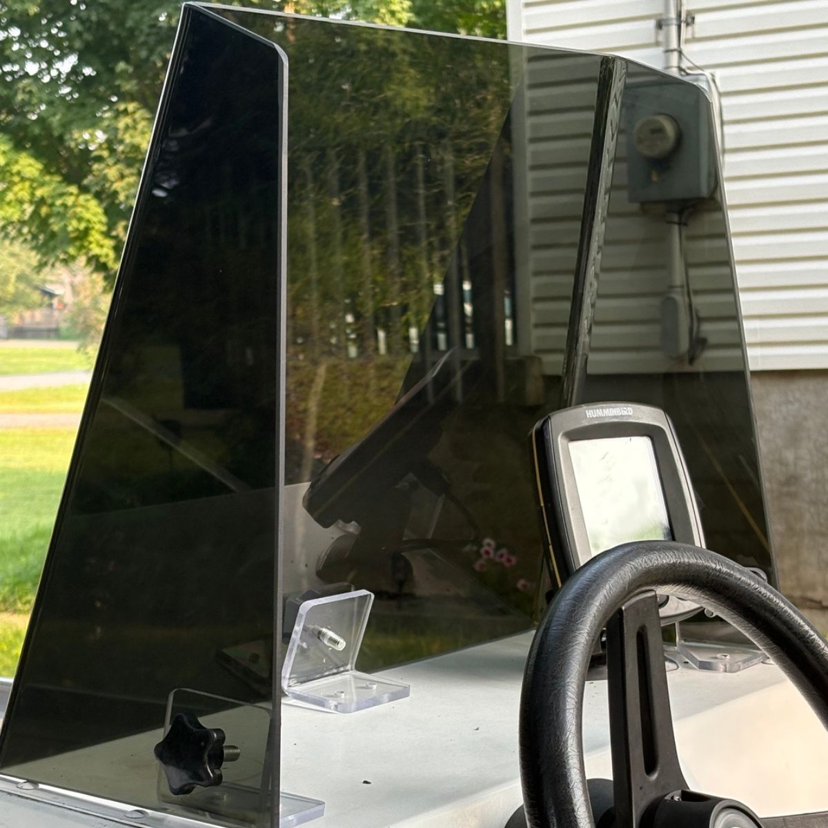Tall smoked acrylic windshield installed on a fishing boat console