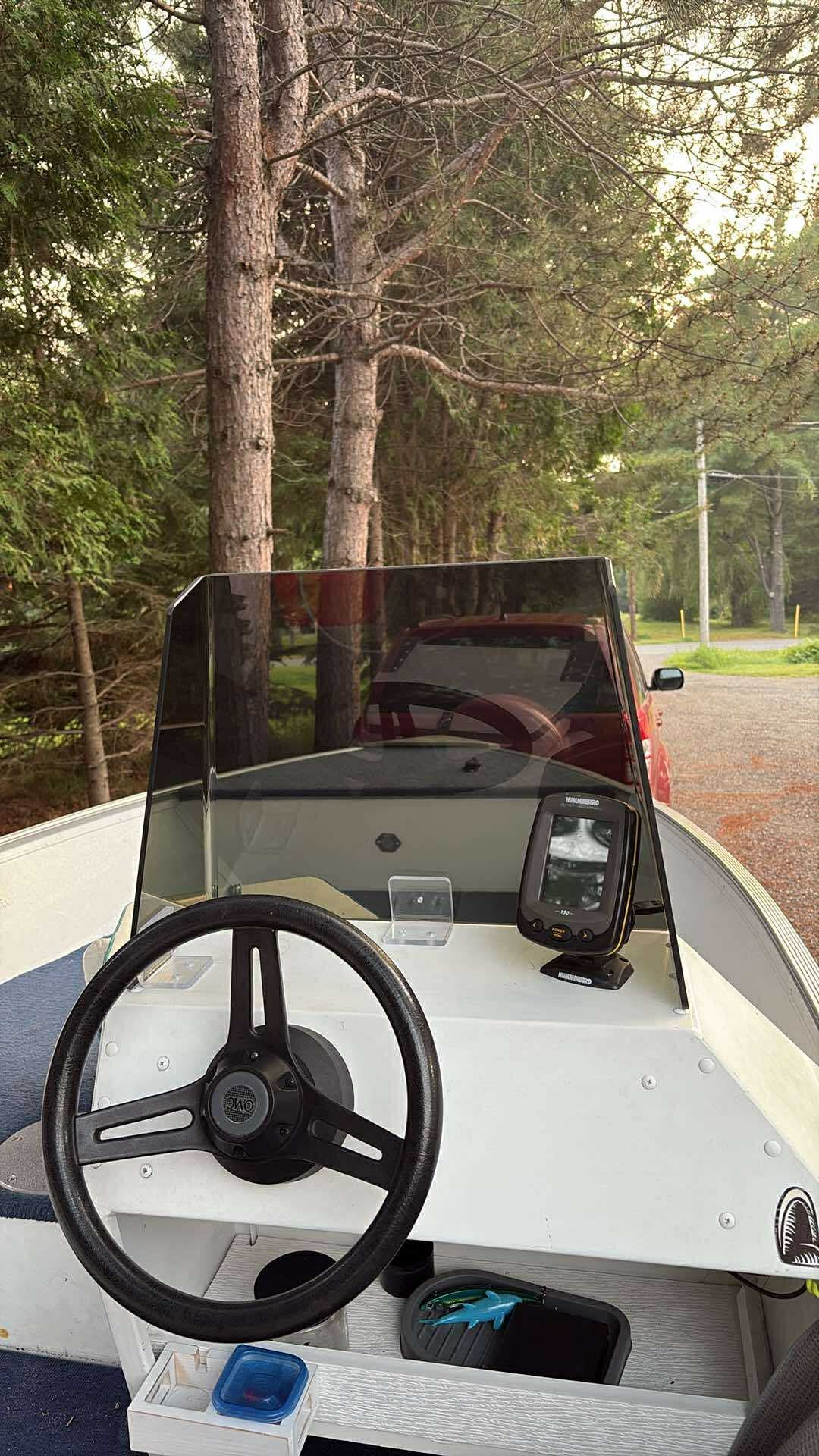Smoked windshield installed in front of a fishing boat steering console